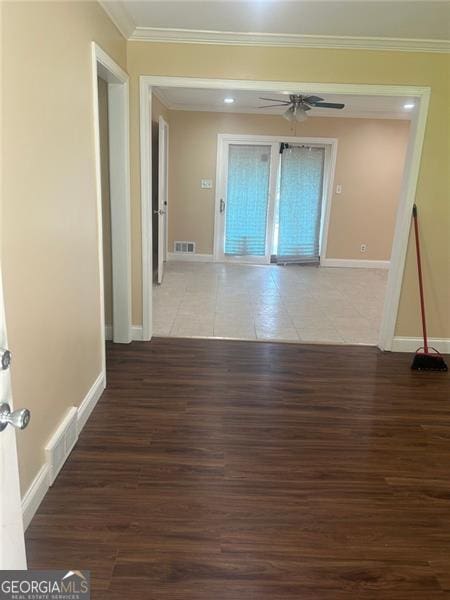 corridor featuring ornamental molding and hardwood / wood-style flooring