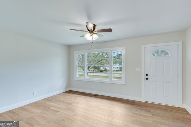 foyer with ceiling fan and light hardwood / wood-style flooring