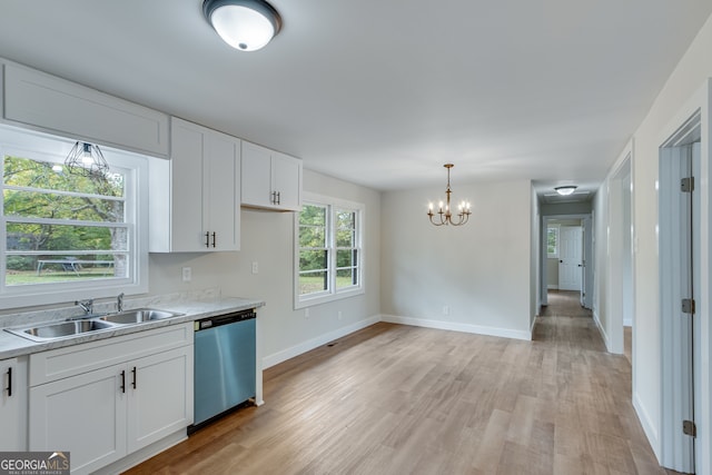 kitchen with stainless steel dishwasher, white cabinets, sink, and light hardwood / wood-style flooring