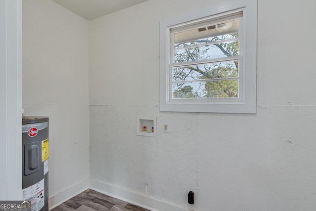 clothes washing area featuring wood-type flooring, washer hookup, and water heater