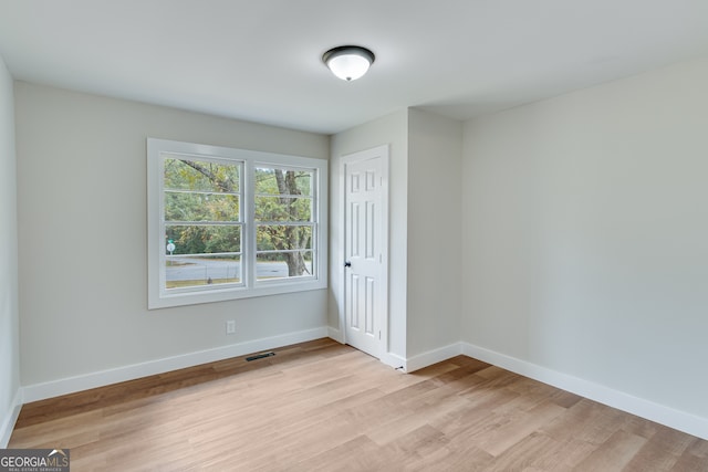 spare room featuring light hardwood / wood-style flooring