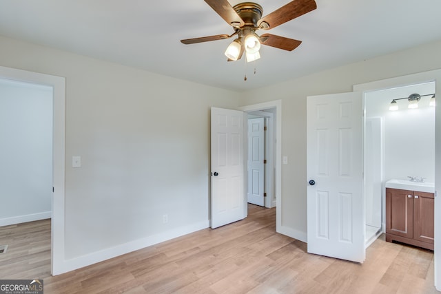 unfurnished bedroom featuring ensuite bath, ceiling fan, sink, and light wood-type flooring