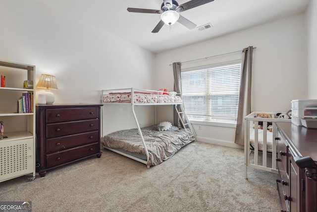 bedroom with ceiling fan and light carpet