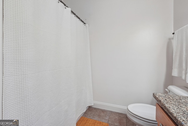 bathroom with tile patterned flooring, vanity, and toilet