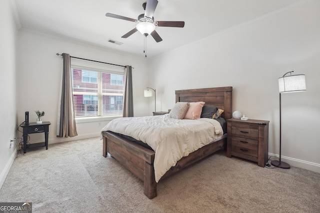 bedroom with light colored carpet, ceiling fan, and crown molding