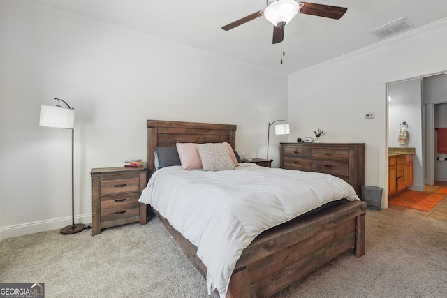 bedroom with ensuite bath, ceiling fan, crown molding, and light carpet