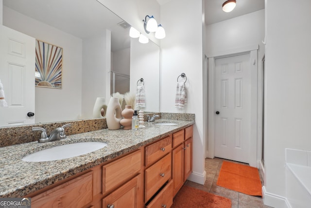 bathroom with tile patterned floors, vanity, and shower with separate bathtub