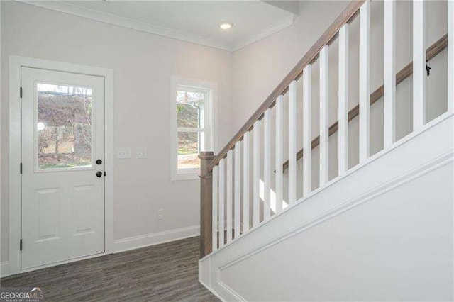 entrance foyer with dark hardwood / wood-style floors and ornamental molding