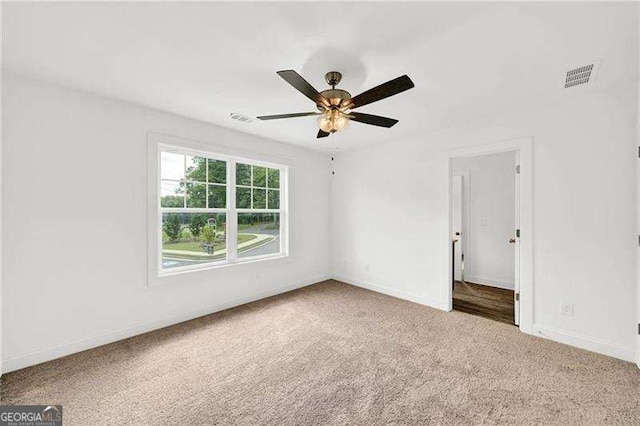 empty room with light carpet and ceiling fan