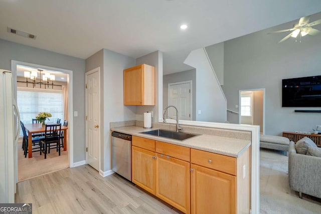 kitchen featuring dishwasher, sink, white refrigerator, ceiling fan with notable chandelier, and light wood-type flooring