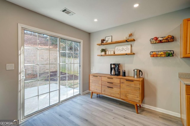 doorway with light hardwood / wood-style floors