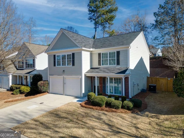 front facade featuring a front yard, central AC unit, and a garage