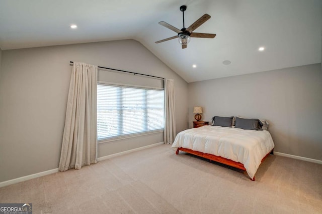 bedroom featuring ceiling fan, light colored carpet, and lofted ceiling