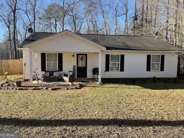 view of front facade featuring an outdoor living space, a front yard, and covered porch