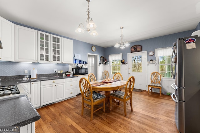 2314 Panorama Dr, Sautee Nacoochee, GA 30571 - kitchen with a notable chandelier, white stove, white cabinets, dark hardwood / wood-style floors, and decorative light fixtures