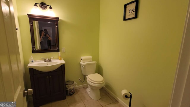 bathroom with tile patterned flooring, vanity, and toilet