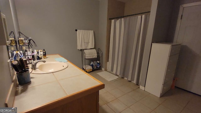 bathroom featuring tile patterned floors, vanity, and a shower with curtain