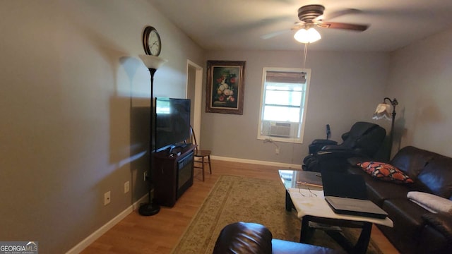 living room featuring light wood-type flooring, ceiling fan, and cooling unit