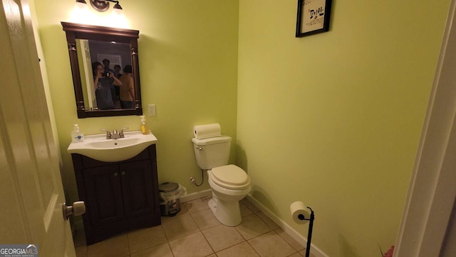 bathroom featuring tile patterned flooring, vanity, and toilet