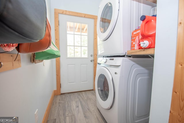 washroom with light hardwood / wood-style flooring and stacked washer / dryer