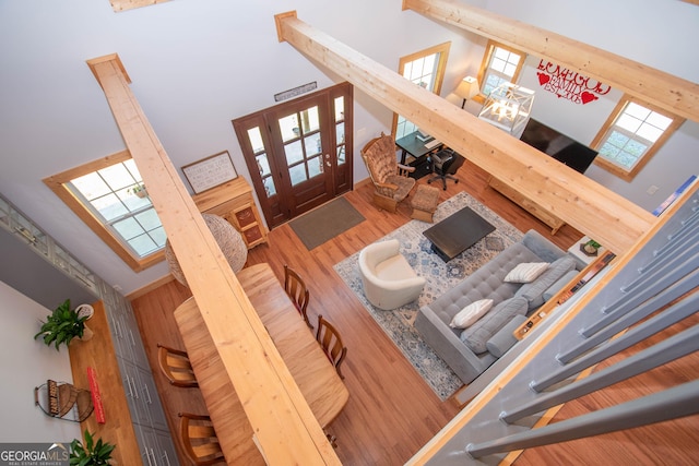 living room with hardwood / wood-style floors and a high ceiling