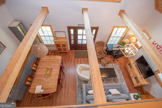 living room with a high ceiling and hardwood / wood-style flooring