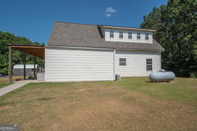 view of property exterior with a yard and a carport