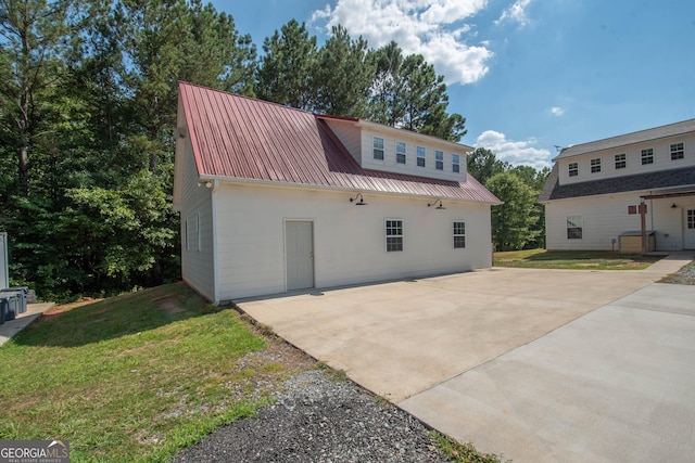 back of house with a patio area and a yard