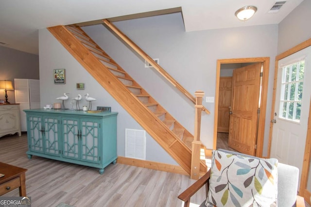 stairs featuring hardwood / wood-style floors