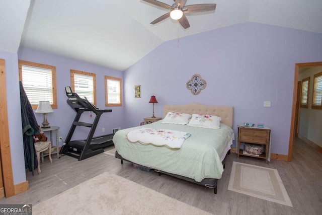 bedroom featuring light wood-type flooring, ceiling fan, and lofted ceiling