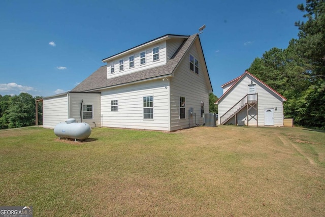 back of house featuring cooling unit and a yard