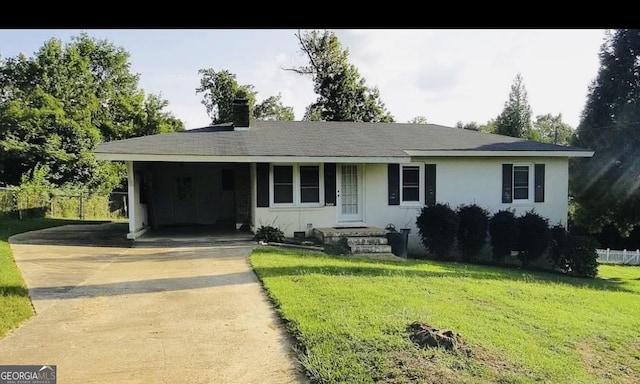 ranch-style home featuring a carport and a front yard