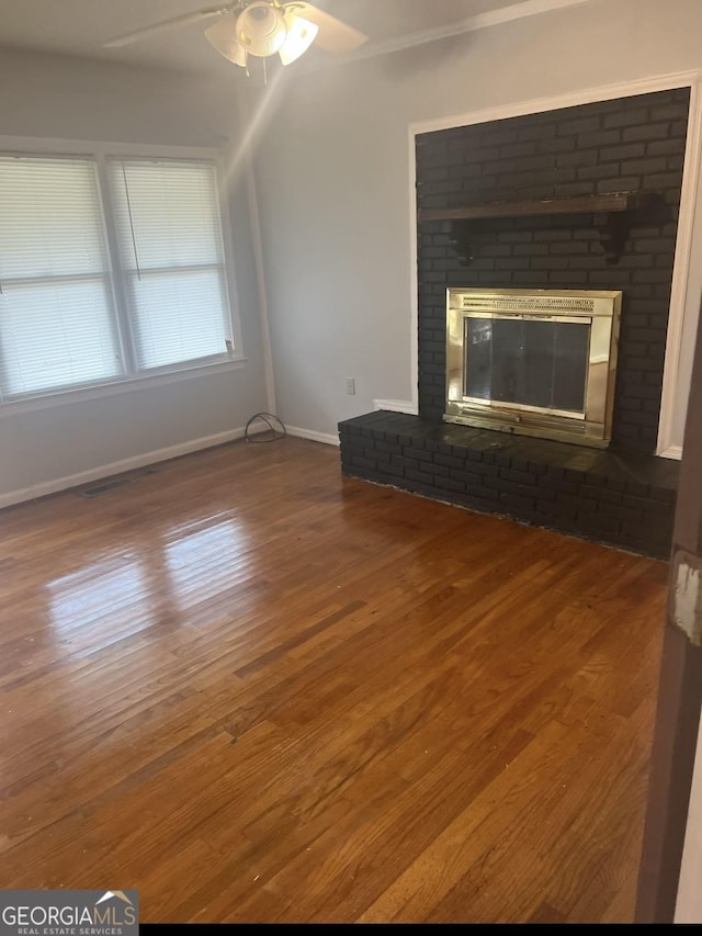 unfurnished living room with ceiling fan, a fireplace, and hardwood / wood-style floors