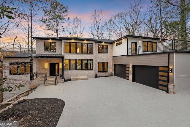 view of front of home featuring a garage and a balcony