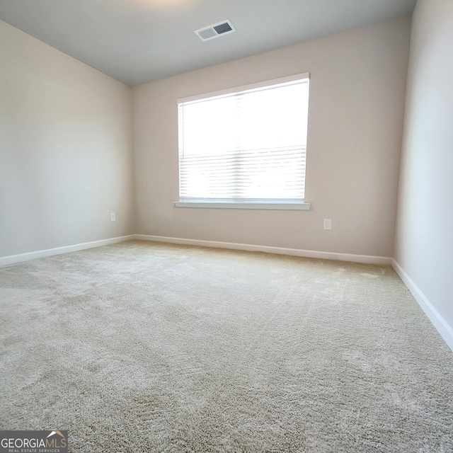 empty room with light colored carpet