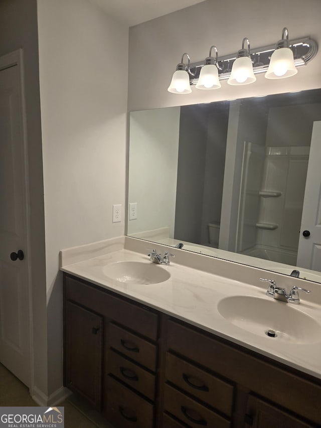 bathroom with tile patterned floors, vanity, and toilet