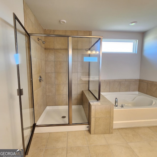 bathroom featuring tile patterned flooring and separate shower and tub