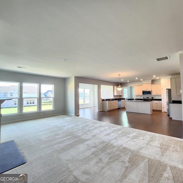 unfurnished living room with dark carpet