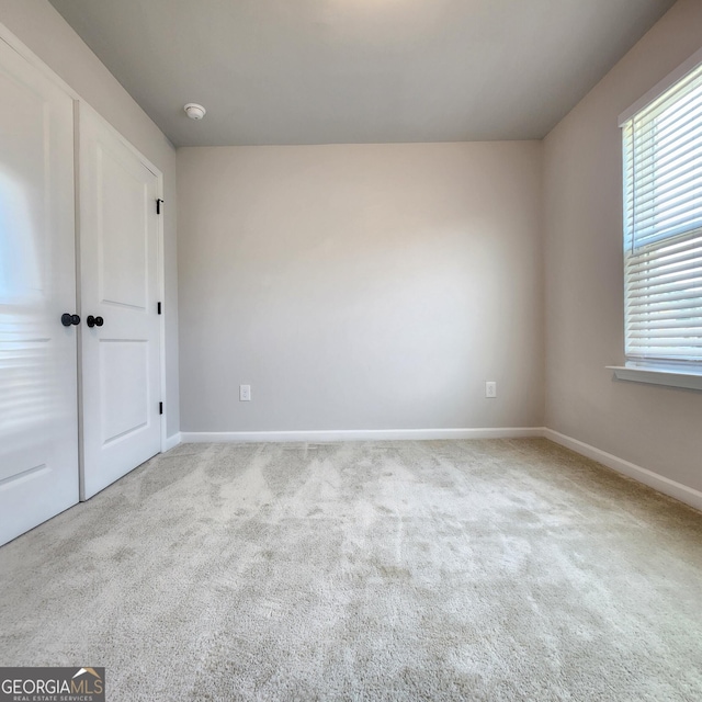 empty room featuring light colored carpet