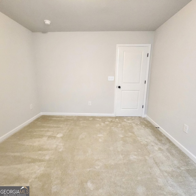 unfurnished room featuring light carpet