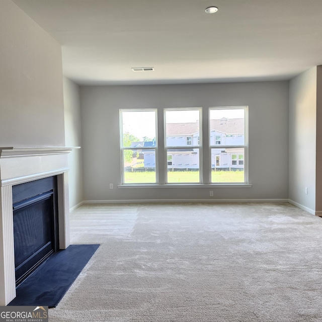 unfurnished living room featuring carpet