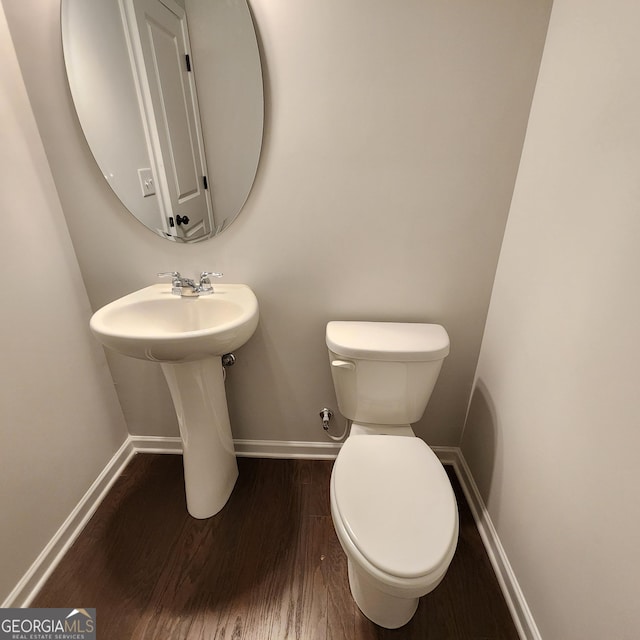 bathroom with hardwood / wood-style floors and toilet