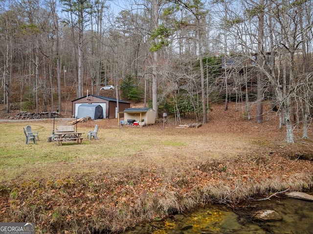 view of yard with a garage and an outdoor structure