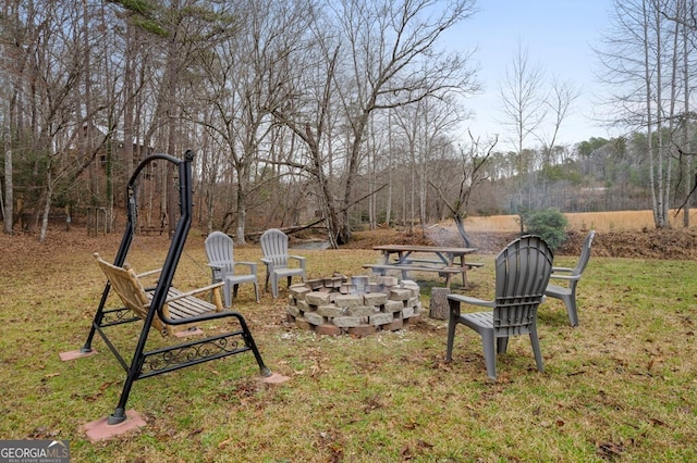 view of yard featuring an outdoor fire pit