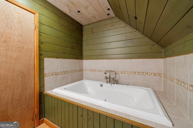 bathroom featuring a tub to relax in, wood walls, wood ceiling, and lofted ceiling