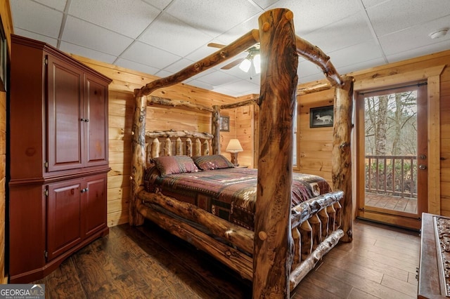 bedroom with a drop ceiling, access to outside, ceiling fan, and dark hardwood / wood-style floors