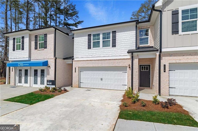 townhome / multi-family property with a garage and french doors