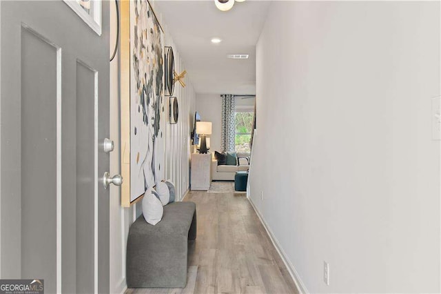 hallway with light hardwood / wood-style flooring