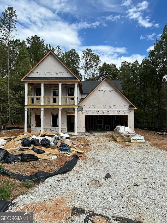 view of front facade featuring covered porch and a garage