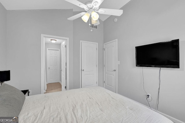 bedroom featuring ceiling fan and high vaulted ceiling